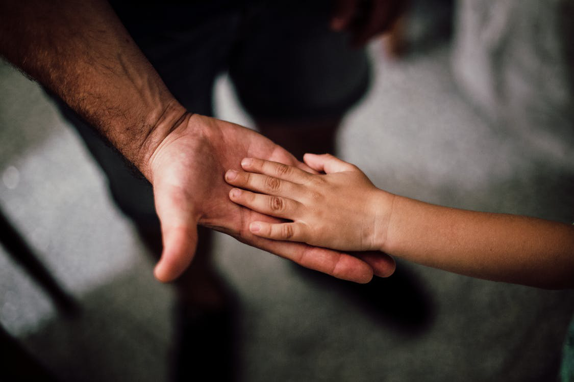 A child’s hand in an adult’s hand