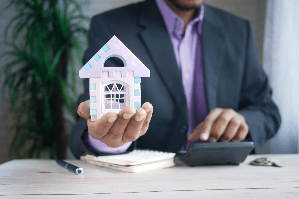 A man holding the house in hand