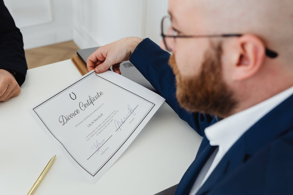 Nanda & Associate Lawyers Canada - A person signing divorce paper
