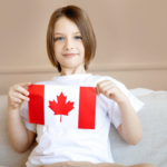 Nanda & Associate Lawyers Canada - A kid holding the Canadian Flag