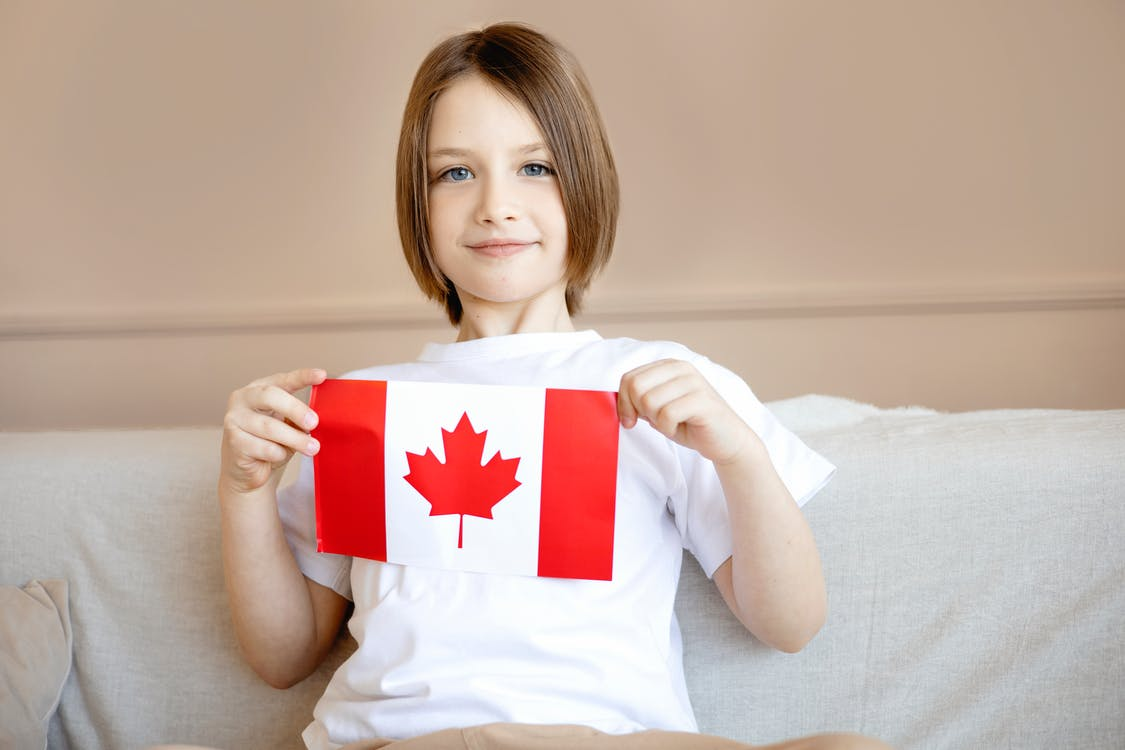Nanda & Associate Lawyers Canada - A kid holding the Canadian Flag