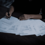 Nanda & Associate Lawyers Canada - an immigration lawyer helping their client with paperwork