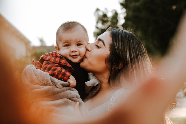 Mother kissing her son