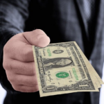 Nanda & Associate Lawyers Canada - A person giving money