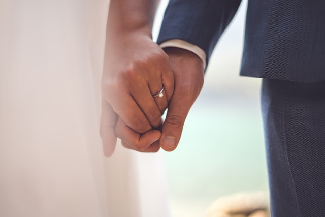 A couple holding hands with each other