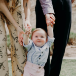 Nanda & Associate Lawyers Canada - A baby holding the hands of parents
