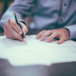 Nanda & Associate Lawyers Canada - A man signing a document