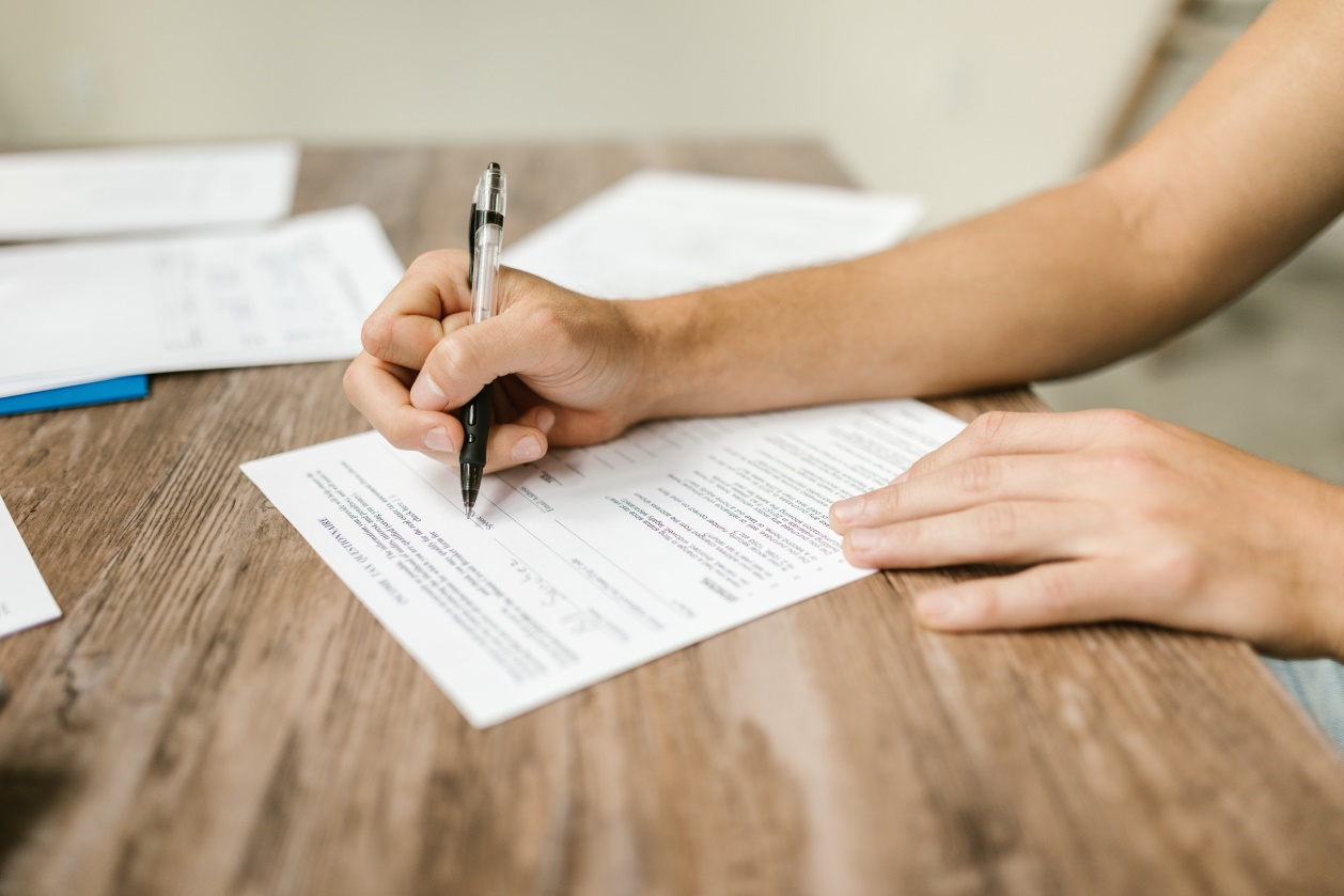 A person filling out a form
