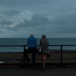 Nanda & Associate Lawyers Canada - Elderly man and woman overlooking the sea on a cloudy evening