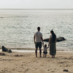 Nanda & Associate Lawyers Canada - Parents with their child on the beach