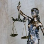Nanda & Associate Lawyers Canada - a bronze statue of Lady Justice holding a balance