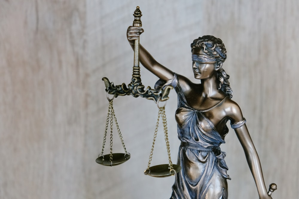 Nanda & Associate Lawyers Canada - a bronze statue of Lady Justice holding a balance