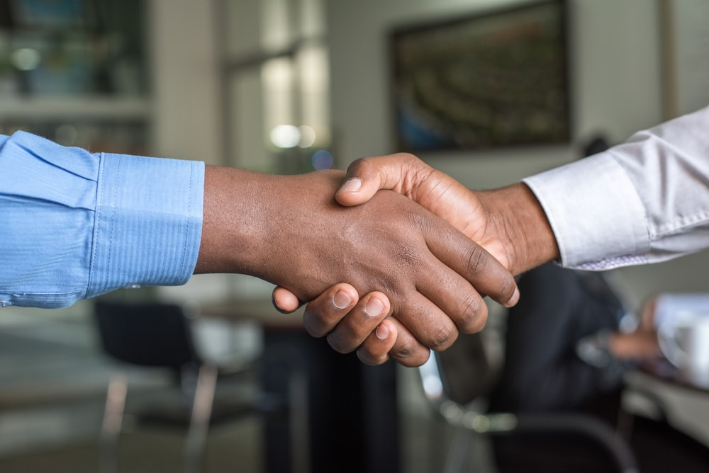 Nanda & Associate Lawyers Canada - a corporate handshake