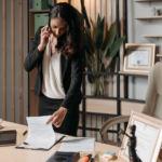 Nanda & Associate Lawyers Canada - Woman speaking on the phone while looking at legal documents