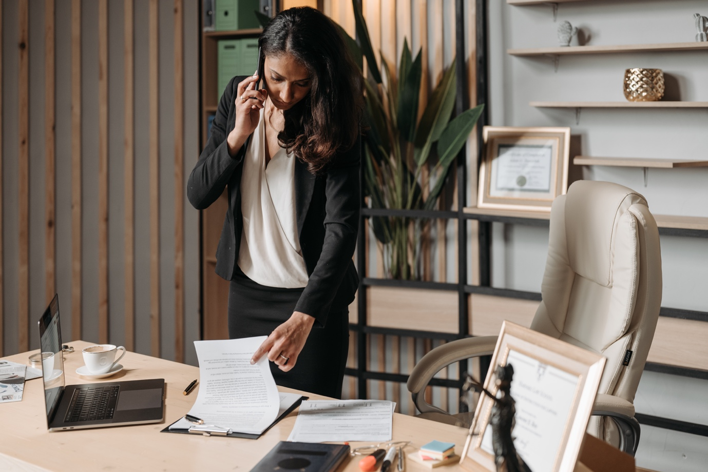 Nanda & Associate Lawyers Canada - Woman speaking on the phone while looking at legal documents