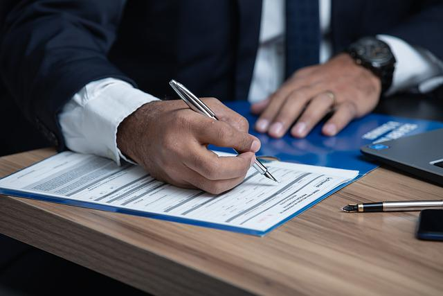 Nanda & Associate Lawyers Canada - An immigration lawyer helping a client fill spousal sponsorship form