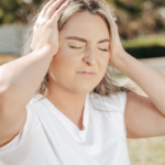 Nanda & Associate Lawyers Canada - A woman holding her head in pain