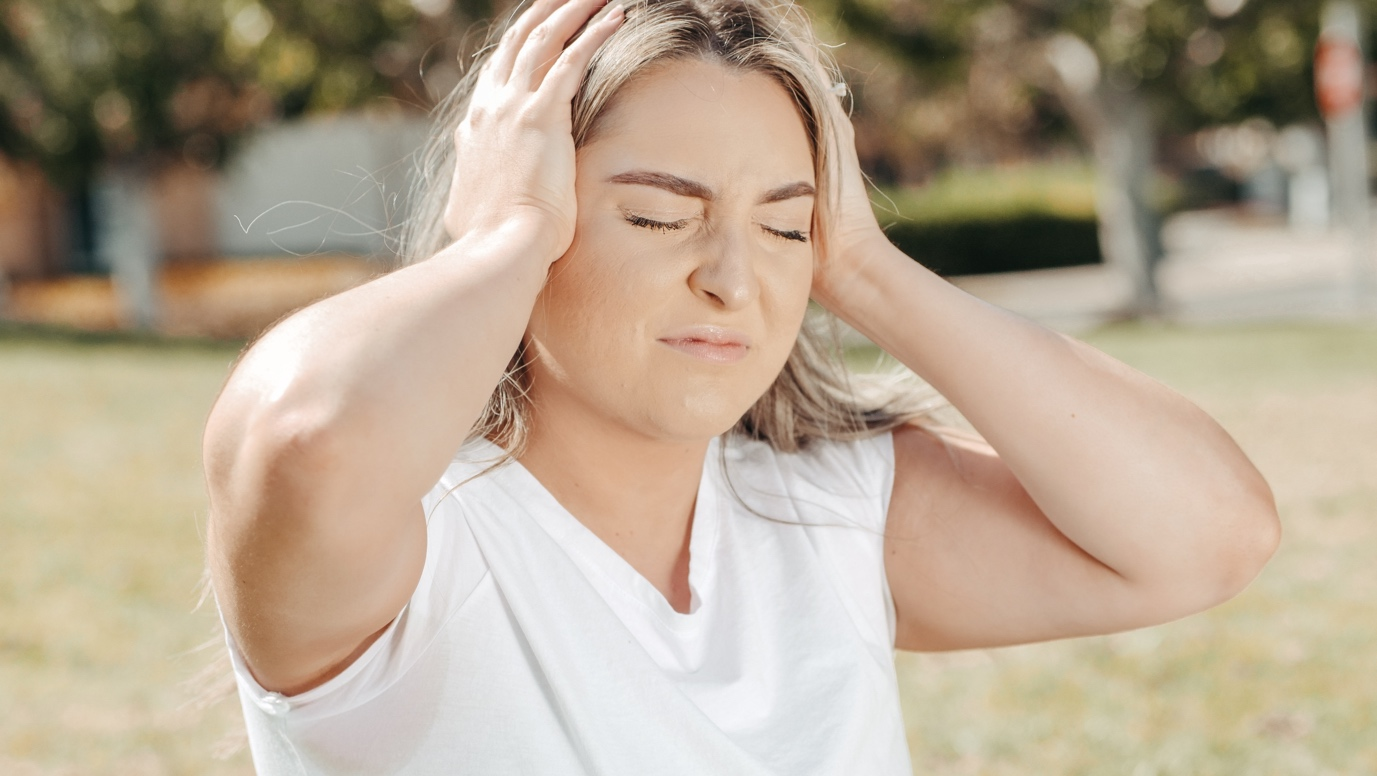 Nanda & Associate Lawyers Canada - A woman holding her head in pain