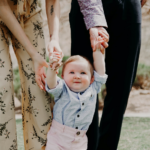 Nanda & Associate Lawyers Canada - A baby holding hand of parents.