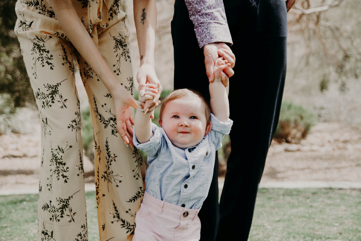 Nanda & Associate Lawyers Canada - A baby holding hand of parents.