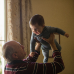 Nanda & Associate Lawyers Canada - A grandparent playing with a kid.