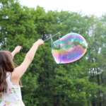 Nanda & Associate Lawyers Canada - A girl playing with a bubble.
