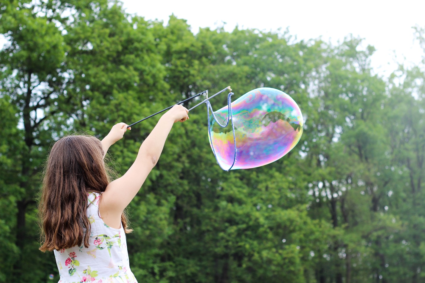 Nanda & Associate Lawyers Canada - A girl playing with a bubble.
