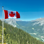 Nanda & Associate Lawyers Canada - Mountain view with a Canadian flag
