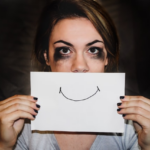 Nanda & Associate Lawyers Canada - A woman holding a smiling sign