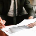Nanda & Associate Lawyers Canada - A man circling number with a red marker