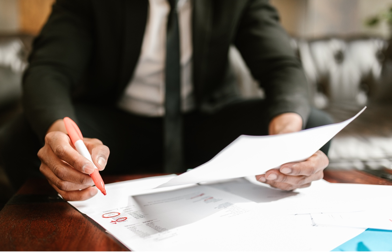 Nanda & Associate Lawyers Canada - A man circling number with a red marker