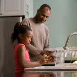 Nanda & Associate Lawyers Canada - A parent teaching a child how to wash hands