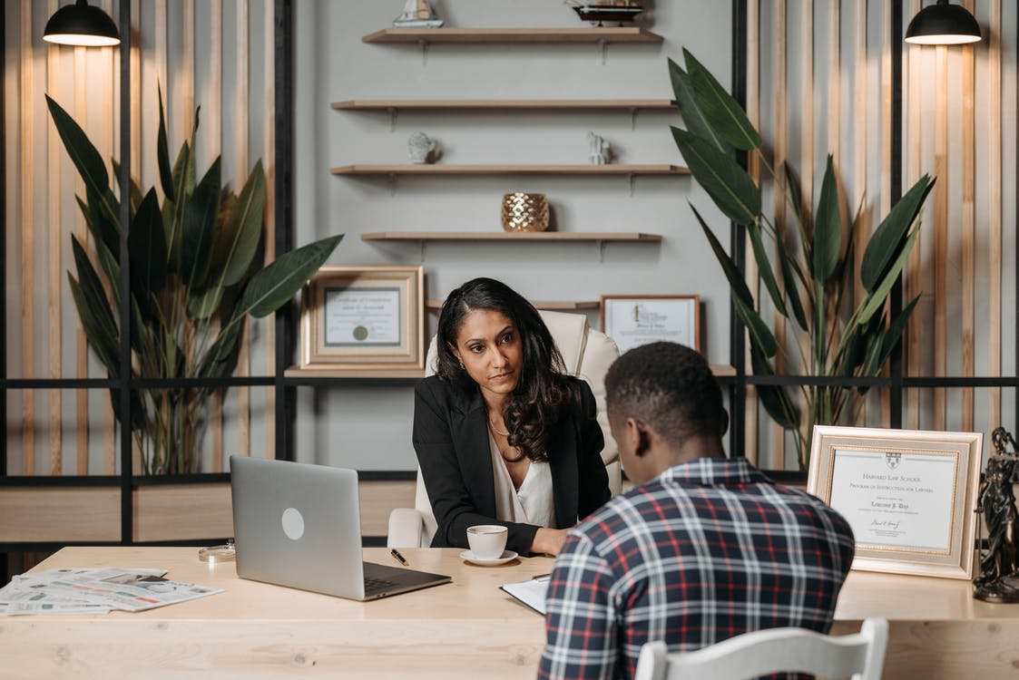 An immigration lawyer discussing registration details with a client