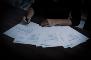 A person completing the paperwork to apply for spousal sponsorship in Canada 
