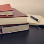 Nanda & Associate Lawyers Canada - A stack of books and a pen