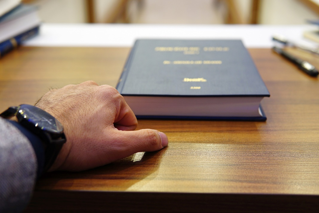 Nanda & Associate Lawyers Canada - A person with legal text in front of them.
