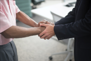 Corporate lawyer and client shaking hands.
