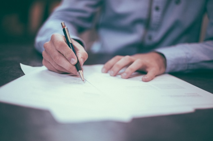 Nanda & Associate Lawyers Canada - Personal injury lawyer signing legal documents