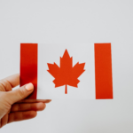 Nanda & Associate Lawyers Canada - A person holding a Canadian flag.