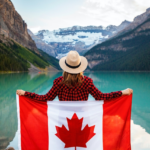 Nanda & Associate Lawyers Canada - A person holding the Canadian flag near a body of water