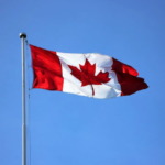 Nanda & Associate Lawyers Canada - Canadian flag against blue sky