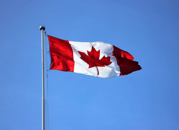 Nanda & Associate Lawyers Canada - Canadian flag against blue sky