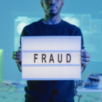 Nanda & Associate Lawyers Canada - Person holding a board saying fraud