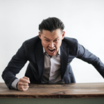 Nanda & Associate Lawyers Canada - An angry person banging the table