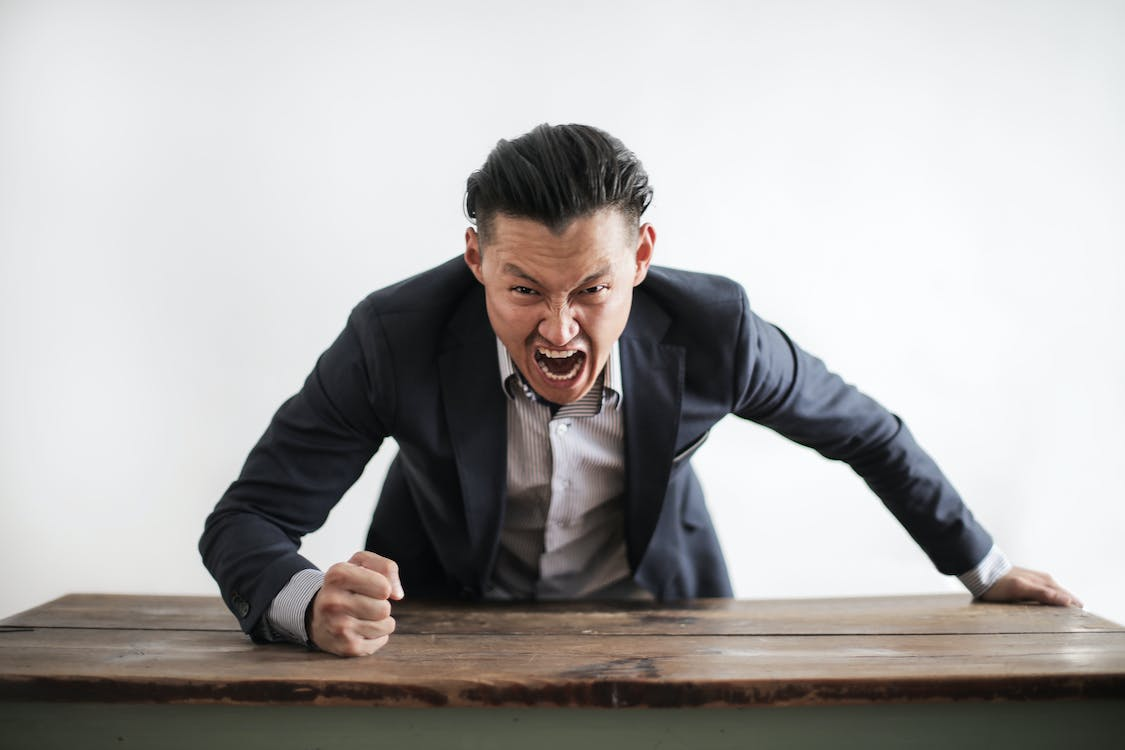 Nanda & Associate Lawyers Canada - An angry person banging the table