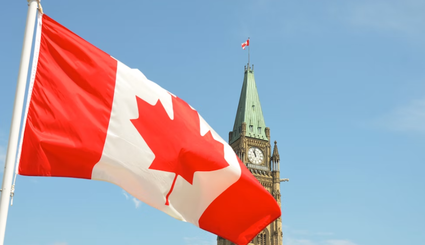 Nanda & Associate Lawyers Canada - Canadian flag in front of clock tower.