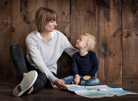 Mother sitting with child on the floor. 