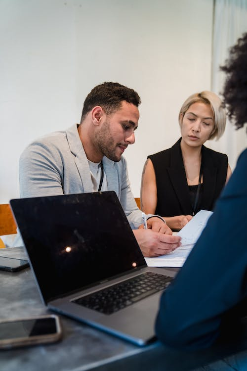  PI lawyer signing a settlement offer with client 