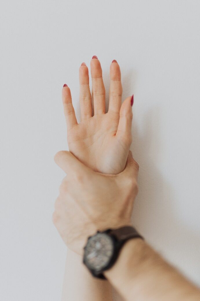 a man hand oppressing a hand of a woman on the wall