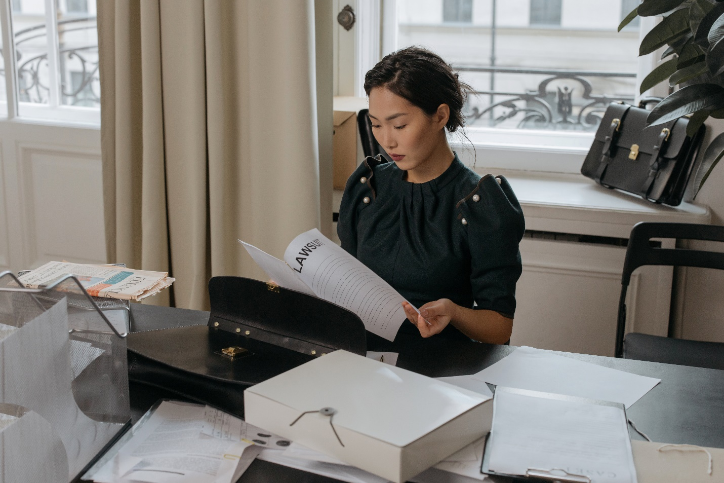 Nanda & Associate Lawyers Canada - a lawyer studying a personal injury case carefully at her desk with files